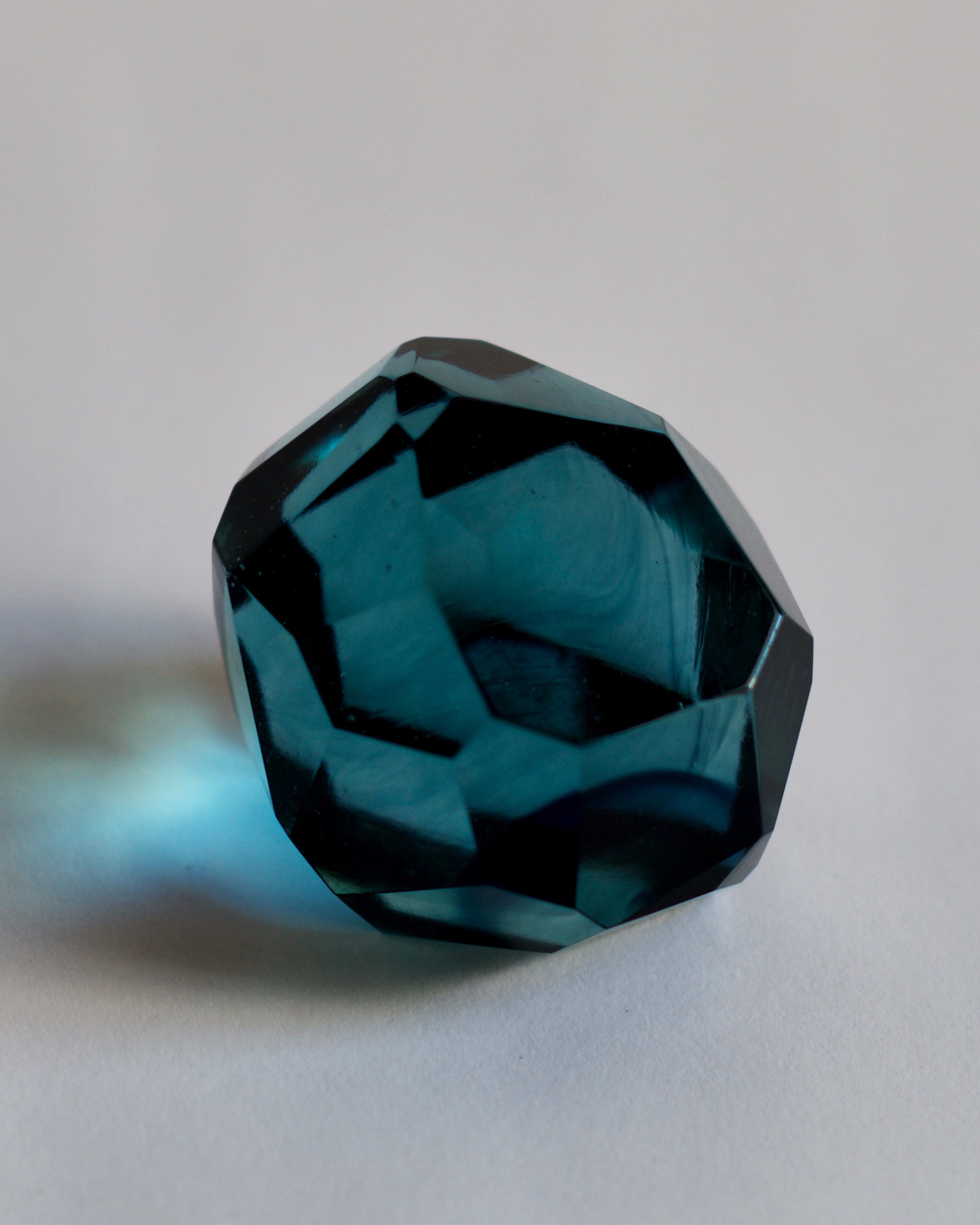 Cropped detail of the blue reclaimed blue jewelry cut paperweight.