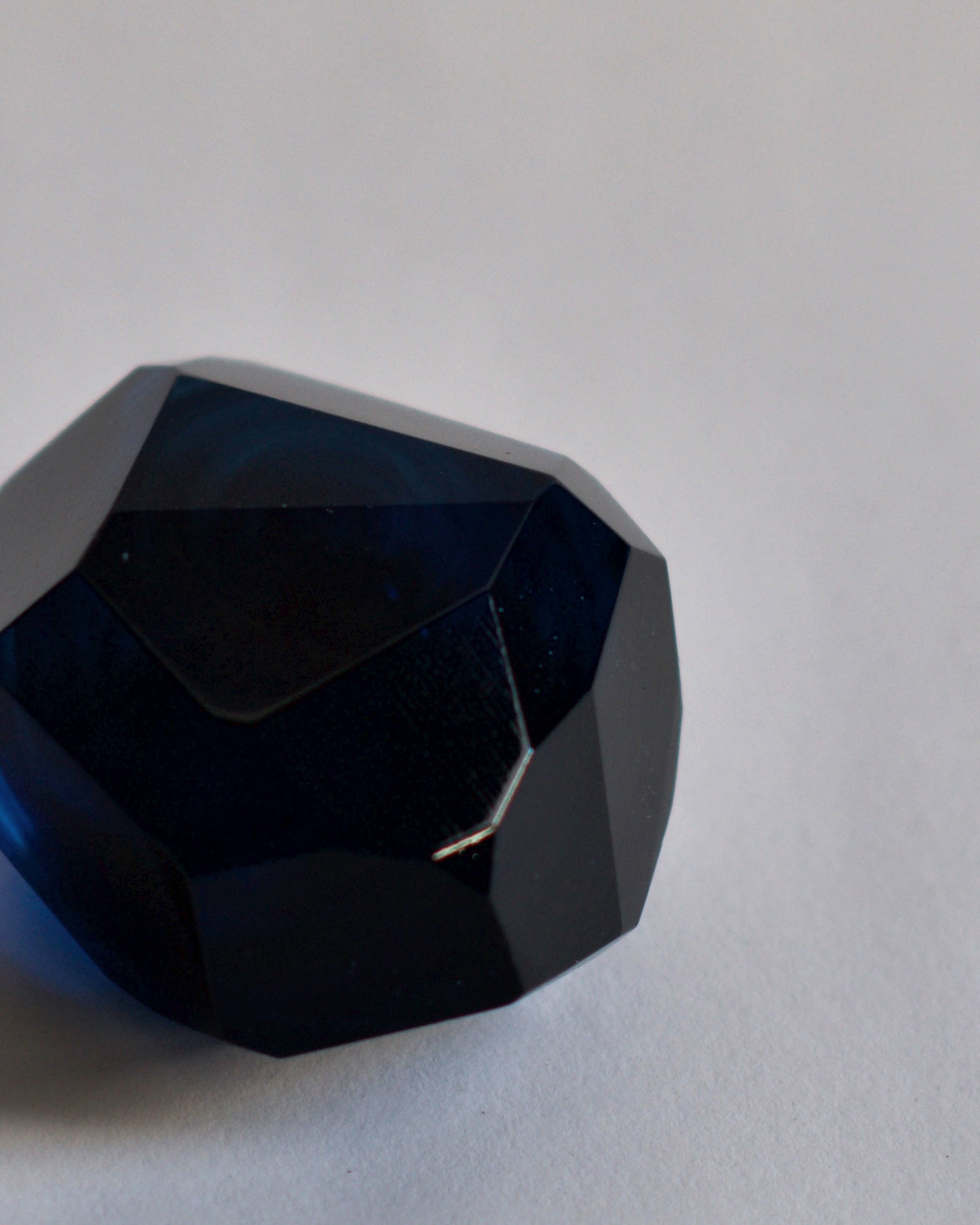 Cropped detail of the dark blue reclaimed blue jewelry cut paperweight. 