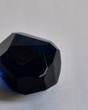 Cropped detail of the dark blue reclaimed blue jewelry cut paperweight. 