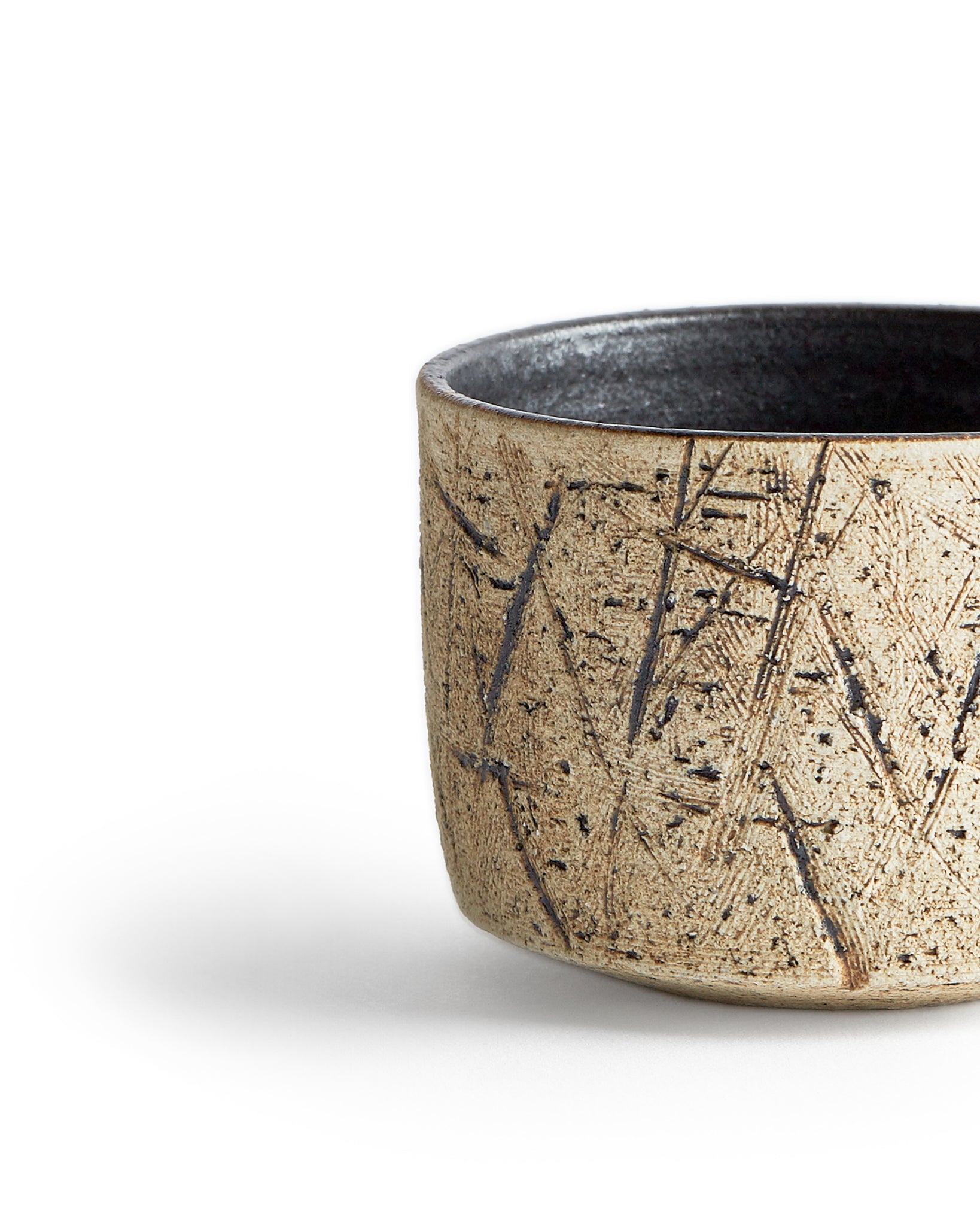 Detailed image of the silhouetted kuro black matcha bowl showing its textures on the exterior..