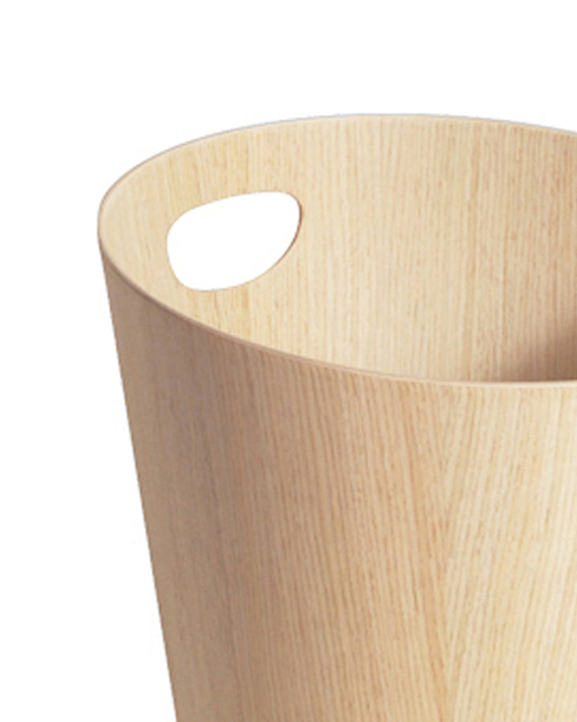 Cropped image focused on handle of white oak paper waste basket with handle by Isamu Saito against white background.
