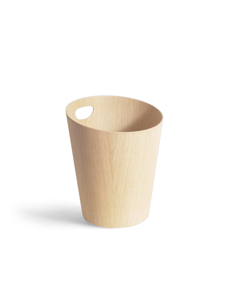 Silhouetted image of white oak paper waste basket with handle by Isamu Saito against white background.
