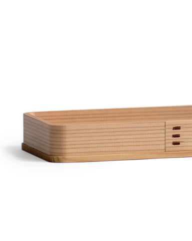 Silhouetted image of the rectangle cedar tray at an angle.