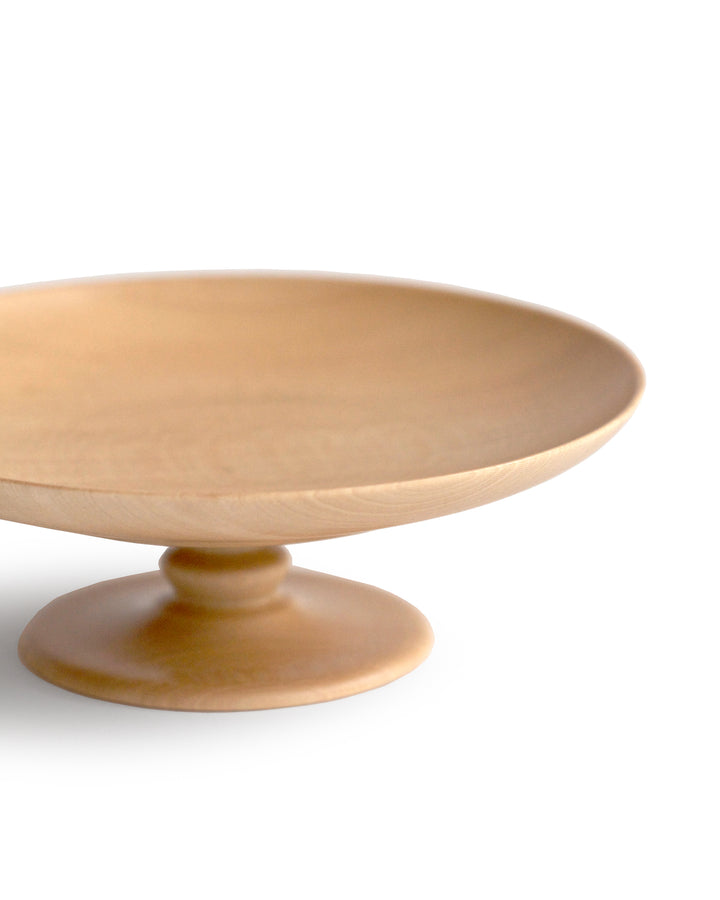 Detailed silhouetted image of the footed plate against white background.