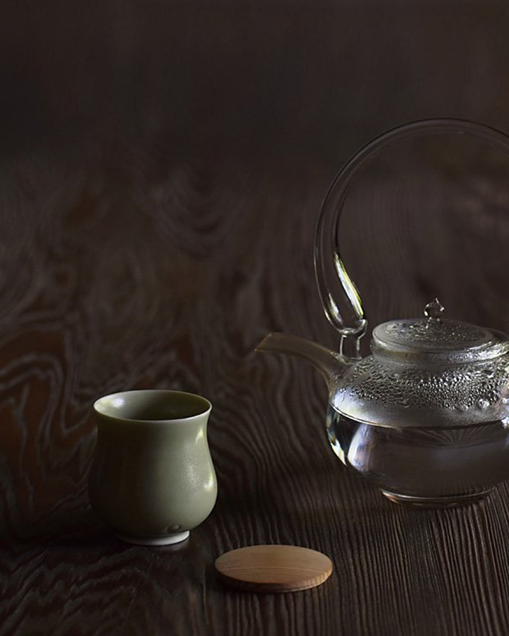 Gourd Teacup by Simplicity beside a glass teapot