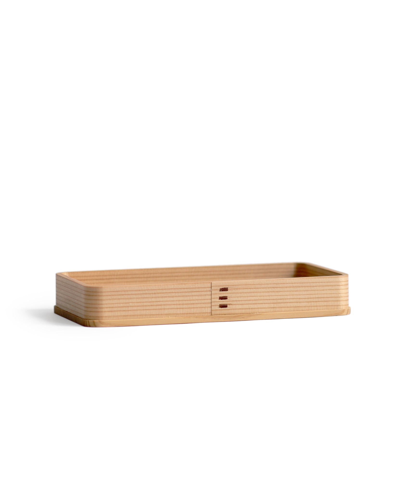 Silhouetted image of the rectangle cedar tray against white background at an angle.