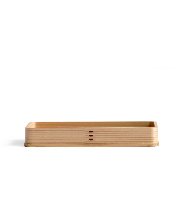 Silhouetted image of the rectangle cedar tray against white background.